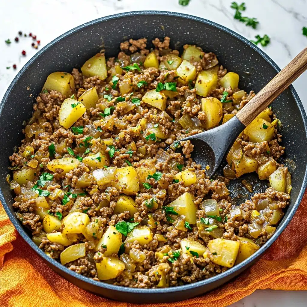 Mexican Picadillo, Mexican Picadillo recipe, easy Mexican dishes, traditional Mexican dinner, flavorful ground beef recipes A dark gray pan filled with cooked ground meat and small yellow potato pieces mixed with green and orange vegetable bits, all in a light brown sauce; some fresh green parsley is sprinkled on top. A black spoon with a wooden handle lifts some mix from the pan. The pan rests on an orange and yellow cloth, on a white marbled surface with red chili flakes scattered around.