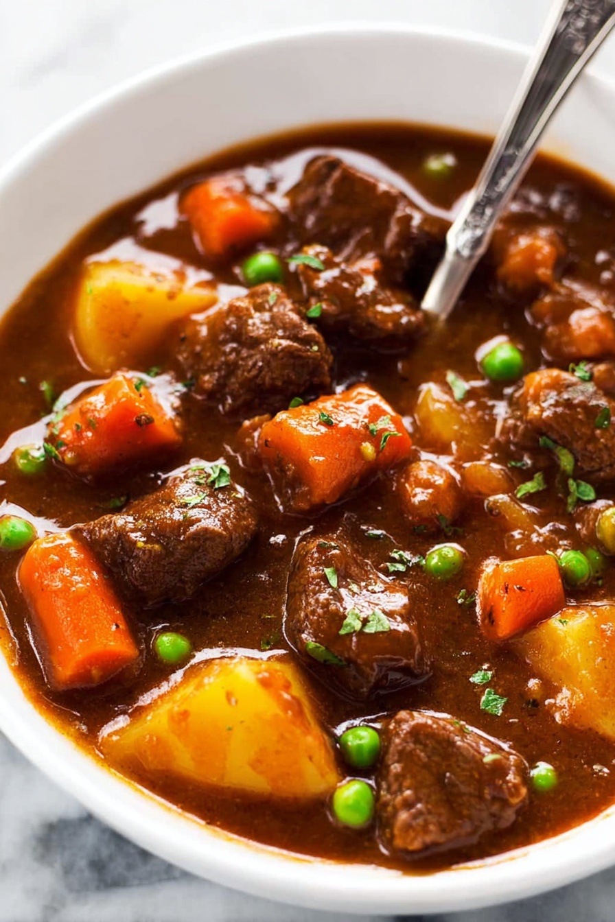 This image shows a thick brown stew filled with several pieces of tender beef, bright orange carrot chunks, and a few green peas scattered throughout. The stew has a rich, smooth, and slightly glossy sauce that coats the meat and vegetables evenly. A large metal ladle in the center lifts a portion of the stew, highlighting the chunky texture of the ingredients and the thick, savory gravy dripping slowly. The background is a white marbled surface. photo taken with an iphone --ar 2:3 --v 7 - Slow Cooker Beef Stew, hearty beef stew, easy slow cooker dinner, tender beef stew recipe, comforting beef stew