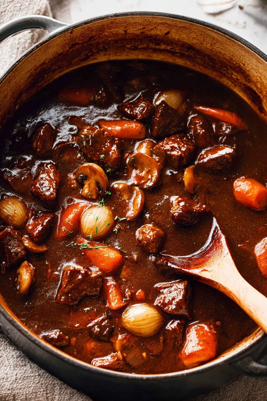 A large pot filled with a thick, dark brown stew containing visible chunks of browned meat, orange carrot slices, small whole pearl onions, and mushrooms, all coated in a shiny sauce. The stew is being stirred by a wooden spoon positioned on the right side inside the pot. The pot sits on a white marbled surface with a textured background of light fabric. Photo taken with an iphone --ar 2:3 --v 7 - Beef Bourguignon, Classic Beef Bourguignon, Beef Burgundy, French beef stew, hearty beef stew