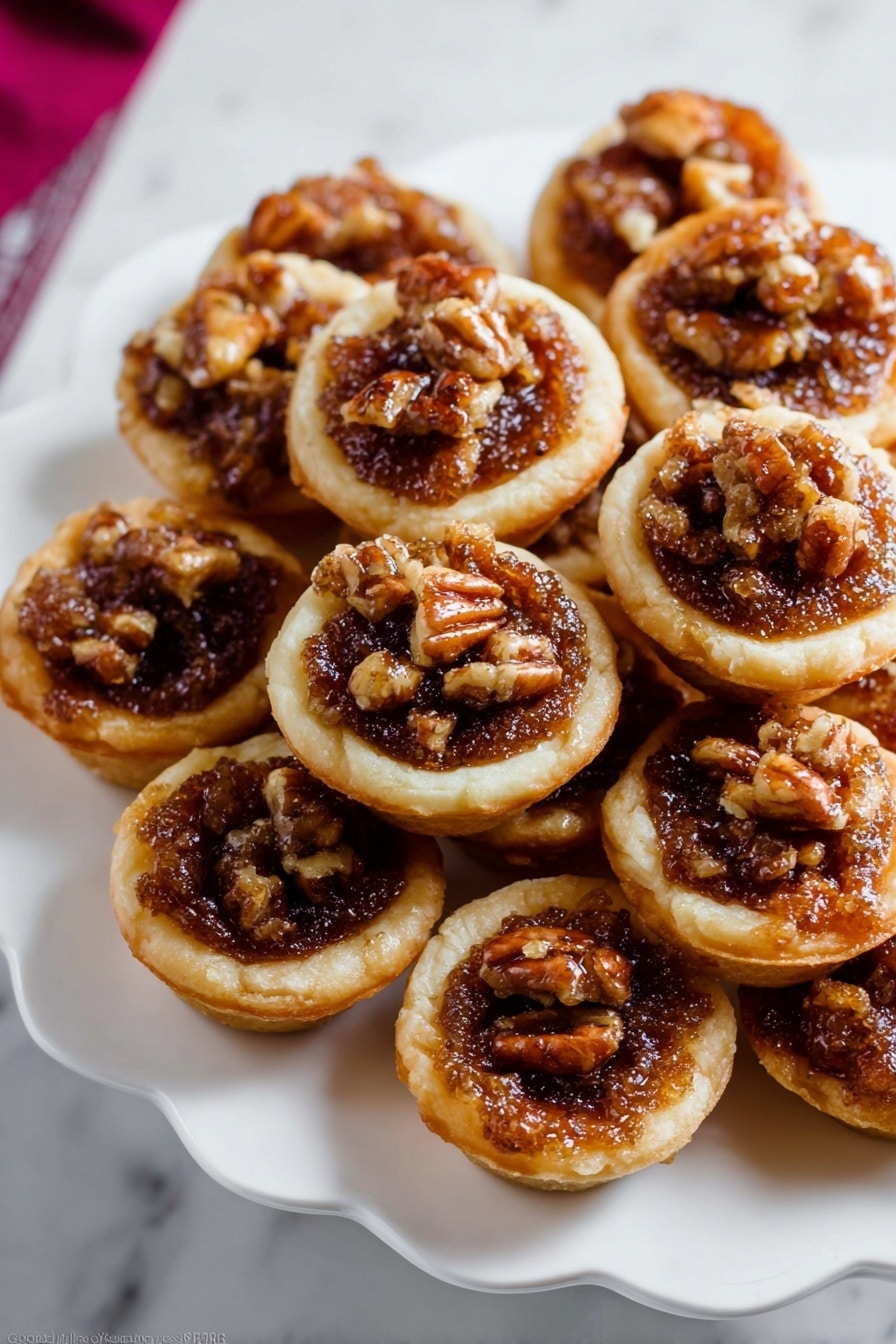 The image shows several small tartlets placed on a white marbled surface. Each tartlet has a golden-brown short crust base that looks crisp. Inside, there is a rich, bubbly filling made of dark brown caramelized nuts, mainly walnuts, giving a textured and slightly glossy look. The top layer is sprinkled with coarse white salt crystals, adding contrast and highlighting the nut filling. The tartlets are close together, showing a rustic and homemade feel with uneven edges and a warm, inviting color mix of golden crust and dark filling. photo taken with an iphone --ar 2:3 --v 7 - Mini Pecan Pies in a Muffin Pan, Pecan Pie Bites, Handheld Pecan Pies, Small Pecan Dessert, Pecan Pie for Holidays