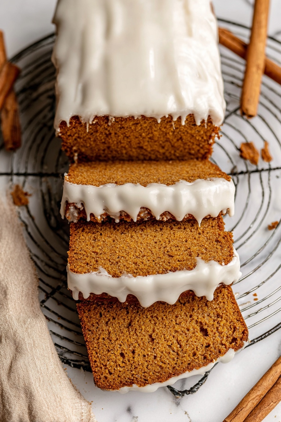 The image shows a loaf of brown cake with three slice pieces cut from it, stacked and spread out below the rest of the loaf. The top of the cake and the edges of the slices have a thick layer of white icing that looks smooth but slightly melted, dripping down the sides. The cake has a dense, moist texture with visible small holes inside. The loaf rests on a round metal wire cooling rack placed on a white marbled surface with a beige cloth and cinnamon sticks nearby. Photo taken with an iphone --ar 2:3 --v 7 - Healthy Pumpkin Bread with Maple Glaze, wholesome pumpkin bread, easy pumpkin bread recipe, moist pumpkin bread with maple glaze, healthy fall baking