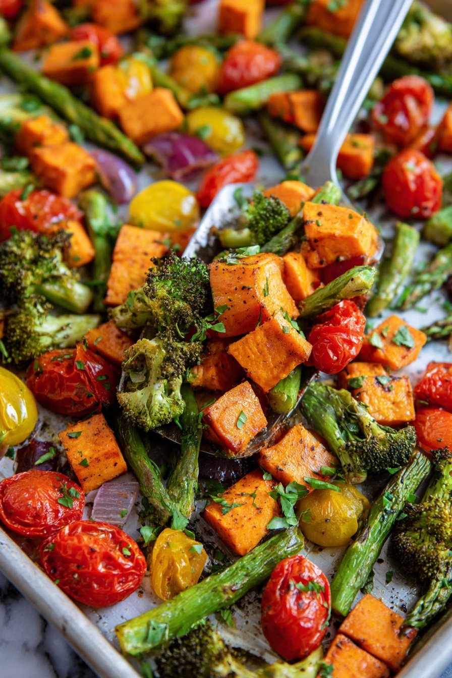 This image shows a close-up of a tray filled with roasted vegetables in layers. The first layer has bright orange sweet potato chunks with a slightly crispy texture. The second layer is made up of green asparagus spears and small broccoli pieces with roasted edges. The third layer consists of red and yellow cherry tomatoes, some whole and some cut in half showing their juicy inside. The vegetables are mixed together with small green herb leaves sprinkled on top. The background surface is a white marbled texture. A metal spatula is lifting a mix of these vegetables in the center of the image, with a woman's hand partly visible on the side. photo taken with an iphone --ar 2:3 --v 7 - Sheet Pan Roasted Vegetables with Sweet Potatoes Broccoli Asparagus Cherry Tomatoes,healthy sheet pan vegetable recipe,easy roasted vegetable dish,vegetable roasting ideas,simple veggie dinner