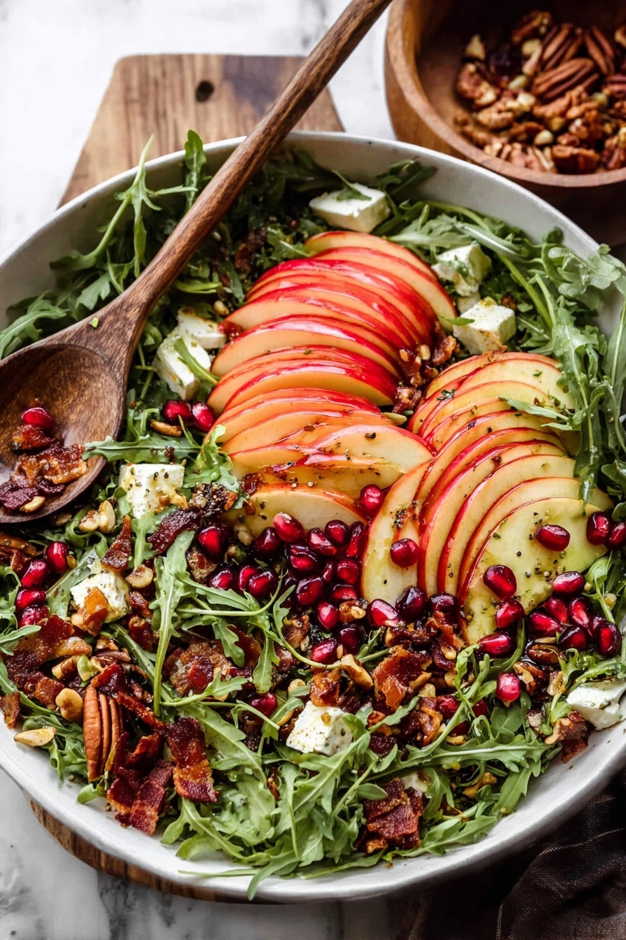 A white bowl filled with a fresh salad layered with bright green arugula leaves as the base, topped with thinly sliced red apple pieces arranged in neat rows across the top. Scattered among the arugula and apples are dark red pomegranate seeds, crunchy toasted seeds and nuts with a golden brown color, small chunks of creamy white cheese, and some crispy bacon bits with a deep reddish-brown hue. A wooden spoon rests on the side of the bowl, and the scene is set on a white marbled surface with a wooden bowl in the background. Photo taken with an iphone --ar 2:3 --v 7 - Autumn Harvest Honeycrisp Apple and Feta Salad, fall apple salad recipes, honeycrisp apple salad, easy autumn salad, seasonal apple salad