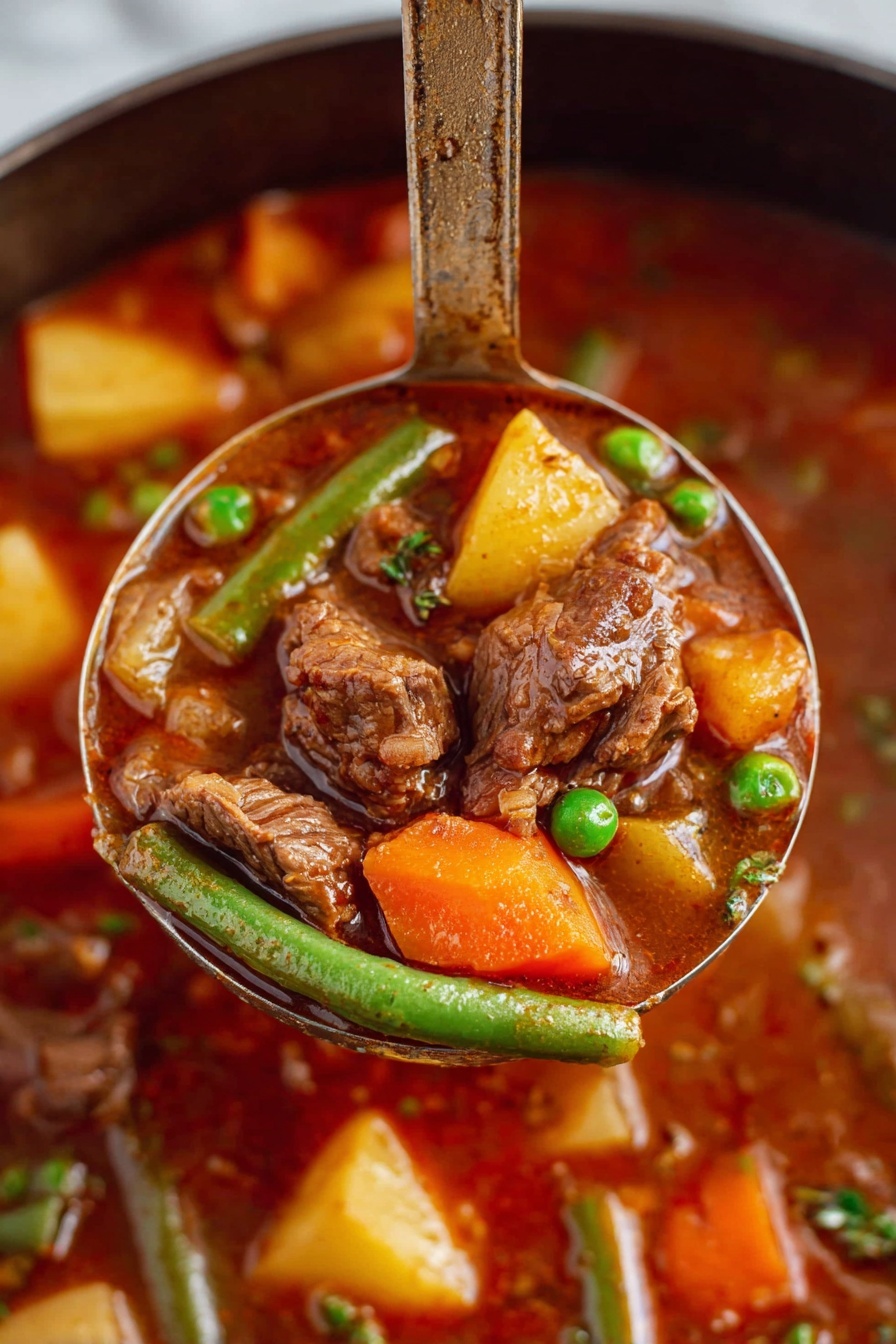 A close-up view of a ladle lifting a rich beef stew filled with soft brown chunks of beef, bright orange carrot pieces, yellow potato cubes, green beans, and green peas all mixed in a thick, deep reddish-brown broth. The background shows more of the stew with similar colorful vegetables and beef pieces visible. The ladle handle stands upright, emphasizing the hearty ingredients and texture of the dish. The scene is set on a white marbled surface. Photo taken with an iphone --ar 2:3 --v 7 - Vegetable Beef Stew, hearty beef stew recipe, easy beef stew, comforting vegetable beef stew, how to make beef stew
