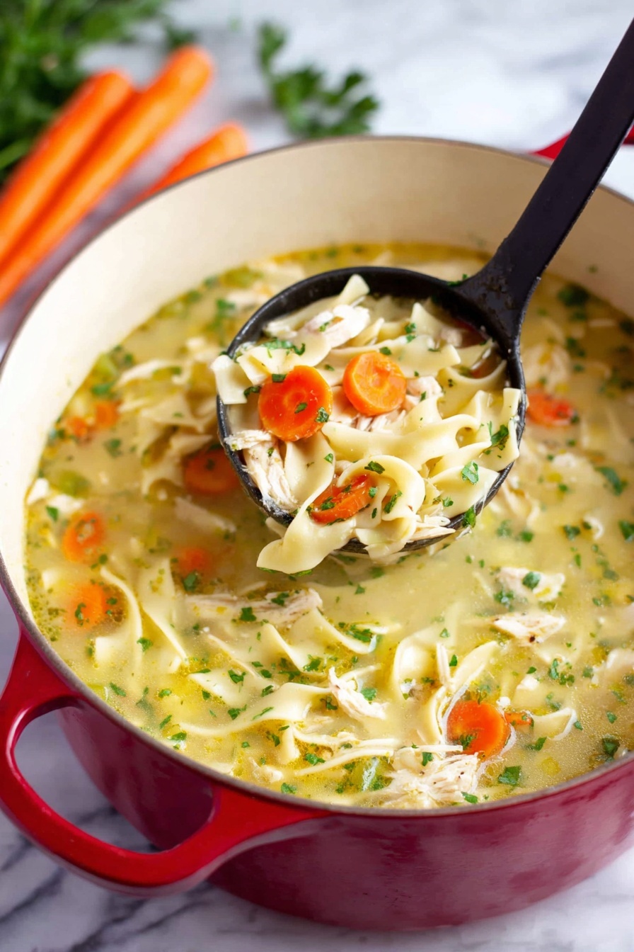 The image shows a red pot filled with chicken noodle soup placed on a white marbled surface. The soup has three main layers: a light yellow broth as the base with visible small green herbs scattered throughout; chunky pieces of white chicken and thick flat noodles spread evenly; and slices of orange carrot and green celery mixed in. A black ladle lifts a portion of soup, showing a close-up of a mix of chicken, noodles, carrot, and celery. In the background, there are some whole carrots and green parsley visible. Photo taken with an iphone --ar 2:3 --v 7 - Healthy Chicken Noodle Soup, nutritious chicken noodle soup, easy healthy soup recipe, wholesome chicken soup, comforting homemade chicken noodle soup