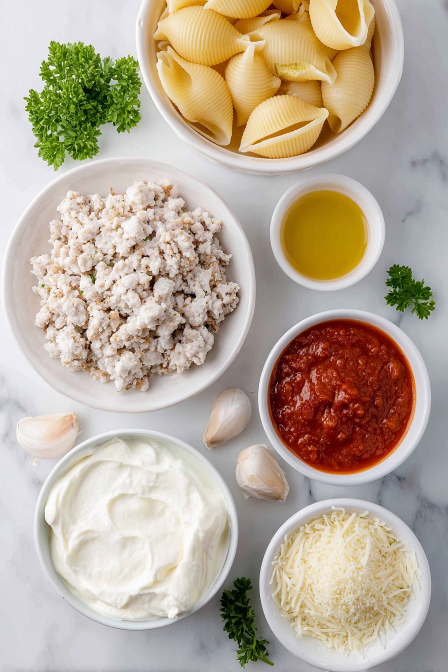 Flat lay of jumbo pasta shells arranged next to a small white bowl of olive oil, a mound of ground chicken pieces seasoned with dried Italian herbs and salt, a large white ceramic bowl filled with creamy whole milk ricotta cheese, a small white bowl holding shredded mozzarella cheese, another small white bowl with grated Parmesan cheese, one whole uncracked large egg with a clean shell, four peeled garlic cloves, a small white bowl containing vibrant red marinara sauce, a small white bowl of light golden Panko breadcrumbs, and a few fresh sprigs of chopped parsley scattered nearby, all placed on a clean white marble surface, soft natural light, photo taken with an iPhone, professional food photography style, fresh ingredients, white ceramic bowls, no bottles, no duplicates, no utensils, no packaging --ar 2:3 --v 7 --p m7354615311229779997 - Chicken Parmesan Stuffed Shells, stuffed pasta shells with chicken and cheese, cheesy baked stuffed shells, Italian stuffed shells recipe, family-friendly chicken pasta dish