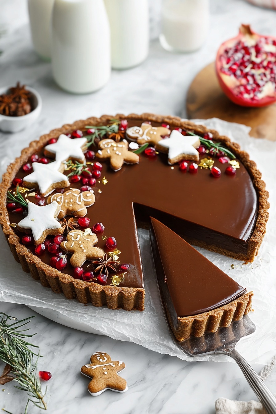 A round tart with a brown crust and a smooth, shiny dark chocolate filling sits on a white marbled surface lined with white paper. Three slices are cut and partly lifted with a spatula showing the thick layers of crust and creamy chocolate inside. The top edge of the tart is decorated with white star-shaped cookies, small gingerbread men with white icing, brown star anise pieces, fresh green rosemary sprigs, scattered shiny red pomegranate seeds, and small gold leaf pieces. Two glass bottles of milk are blurred in the background on the white marbled surface. A partially opened pomegranate on a wooden board is also visible. Photo taken with an iphone --ar 2:3 --v 7 - Vegan Gingerbread Chocolate Tart, vegan holiday dessert, plant-based gingerbread tart, vegan Christmas dessert, chocolate gingerbread tart