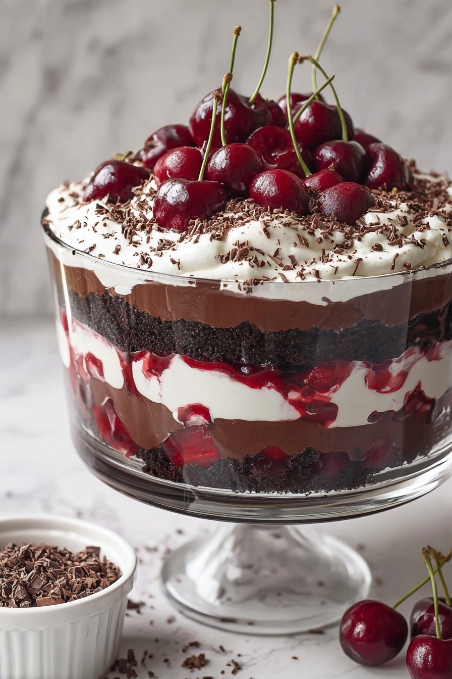 A clear glass dessert cup shows a layered cherry chocolate dessert. The bottom layer is dark chocolate pudding with whole cherries visible through the glass. Above this is a mix of cherry sauce and small chunks of dark chocolate cake. On top, there is a thick layer of white whipped cream sprinkled with dark brown chocolate shavings. Two whole cherries, one with a long stem, sit on the whipped cream. A woman's hand holds a spoon digging into the dessert. The scene is set on a white marbled surface with whole cherries and a white cloth nearby. Photo taken with an iphone --ar 2:3 --v 7 - Black Forest Cherry Trifle, Black Forest dessert, cherry trifle recipe, chocolate cherry dessert, layered trifle sweet