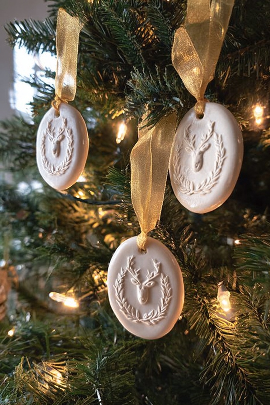 The image shows a Christmas tree decorated with three white oval ornaments, each with a raised design featuring a reindeer head surrounded by a laurel wreath. Each ornament is hung with a shiny golden ribbon tied in a simple loop. The tree has green needles with warm white string lights softly glowing around the ornaments, creating a cozy and festive look. The background is softly blurred, emphasizing the details and texture of the ornaments and the pine needles. photo taken with an iphone --ar 2:3 --v 7 - Springerle Cookies, Springerle Cookies Recipe, Traditional Springerle Cookies, Anise Springerle Cookies, Embossed Cookie Recipe