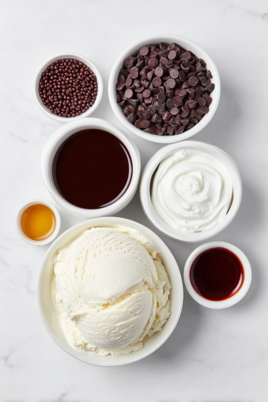 Flat lay of a large scoop of creamy vanilla ice cream on a simple white ceramic plate, a small white bowl filled with rich dark chocolate syrup, another small white bowl holding shiny chocolate sprinkles, a small white bowl with mini dark chocolate chips, a small white bowl containing smooth hot chocolate, a small white bowl with amber Kahlua liquor, and a small white bowl with deep brown dark creme de cacao liqueur, all arranged symmetrically and balanced on a clean white marble surface, soft natural light, photo taken with an iPhone, professional food photography style, fresh ingredients, white ceramic bowls, no bottles, no duplicates, no utensils, no packaging --ar 2:3 --v 7 --p m7354615311229779997 - Chocolate Hot Chocolate Cocktail, decadent hot chocolate drinks, spiked hot chocolate recipes, boozy chocolate cocktails, festive chocolate beverages