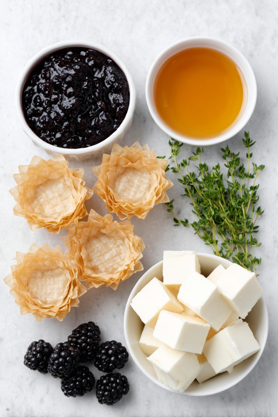 Flat lay of fresh golden mini phyllo shells arranged neatly, a small white ceramic bowl with glossy deep purple blackberry jam, another small white bowl filled with clear golden honey, creamy pale off-white cubes of brie cheese without rind, a handful of plump fresh blackberries with a rich dark purple hue, and a few sprigs of vibrant green fresh thyme artfully placed, all ingredients balanced symmetrically and naturally placed on a clean white marble surface, soft natural light, photo taken with an iPhone, professional food photography style, fresh ingredients, white ceramic bowls, no bottles, no duplicates, no utensils, no packaging --ar 2:3 --v 7 --p m7354615311229779997 - Brie and Blackberry Phyllo Cups, easy Brie and Blackberry appetizer, quick fruit and cheese appetizer, elegant party appetizers, colorful summer snacks