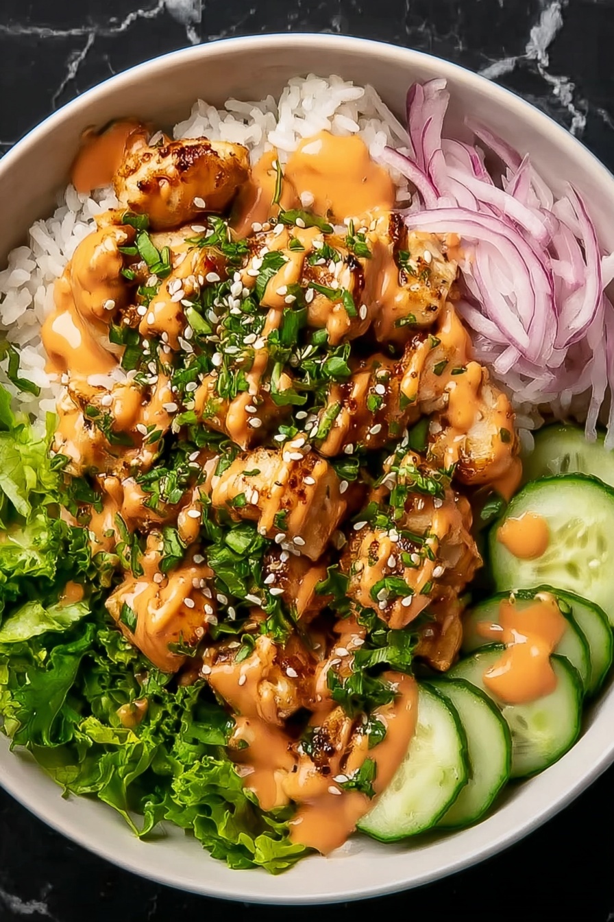 A bowl with a base layer of white rice topped with chopped green lettuce and thinly sliced red onions on one side. Small, golden-brown grilled chicken pieces are placed in the center, covered with green chopped herbs and white sesame seeds. On the right side, there are thin, round cucumber slices. The dish is drizzled with an orange creamy sauce over the chicken and cucumbers. The bowl is white and set on a white marbled surface. Photo taken with an iphone --ar 2:3 --v 7 - Bang Bang Chicken Bowl, spicy mayo recipe, crispy chicken bowl, quick Asian chicken dish, easy weeknight dinner