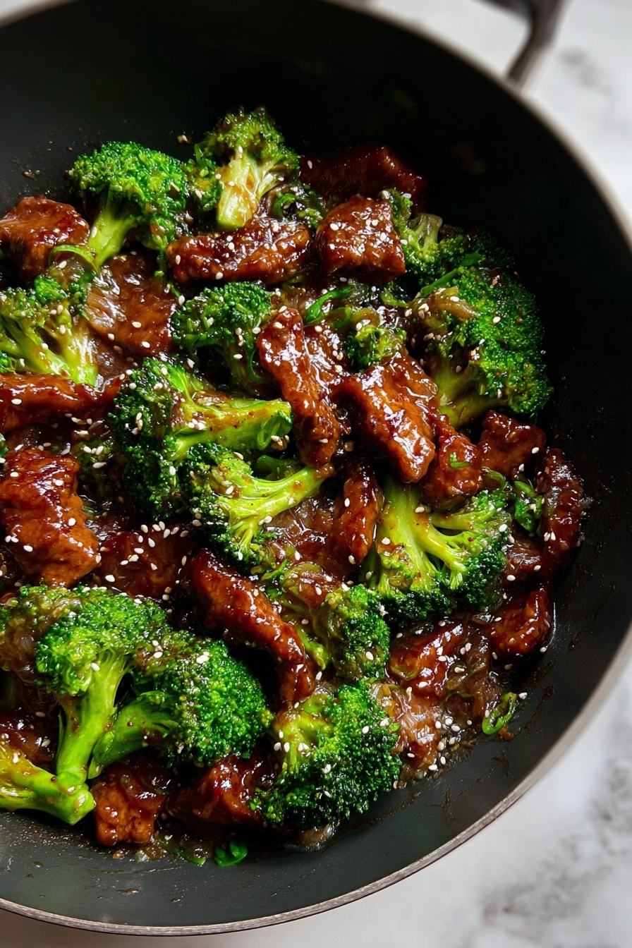 The dish shows about two layers mixed together in a black wok on a white marbled surface. The first layer is bright green broccoli florets that look fresh and slightly glossy. The second layer consists of shiny, brown pieces of meat coated in a thick sauce. Light-colored sesame seeds are sprinkled evenly on top, adding small spots of contrast. The sauce gives the meat a wet and glossy texture, while the broccoli adds a rough, natural look. The whole dish looks warm and tasty, with a good mix of colors and textures. Photo taken with an iphone --ar 2:3 --v 7 - Beef with Garlic Sauce, Chinese beef stir-fry, easy garlic sauce recipe, quick weeknight dinner, homemade Chinese takeout