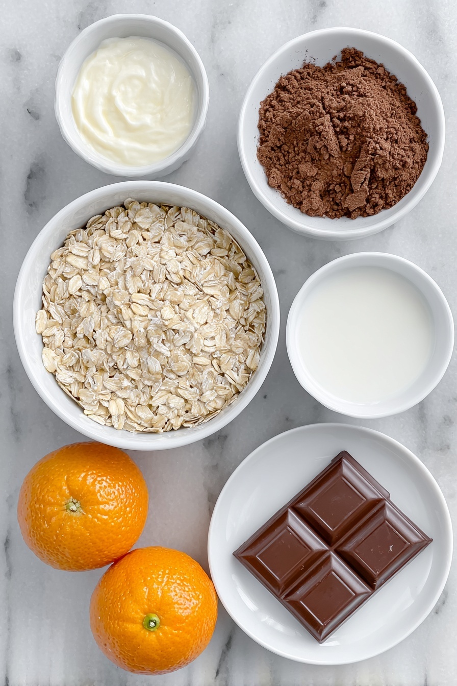 Flat lay of a small white ceramic bowl filled with pale beige porridge oats, a small white bowl of creamy semi-skimmed milk, a small white bowl of clear water, a small white bowl of rich dark brown cocoa powder, two bright orange satsumas—one whole and one cut in half showing juicy segments, and a single square of glossy dark chocolate placed on a white ceramic plate, all arranged in perfect symmetry, placed on a clean white marble surface, soft natural light, photo taken with an iPhone, professional food photography style, fresh ingredients, white ceramic bowls, no bottles, no duplicates, no utensils, no packaging --ar 2:3 --v 7 --p m7354615311229779997 - Chocolate Orange Porridge, breakfast with chocolate and orange, quick healthy breakfast recipes, cozy morning porridge, citrus and cocoa oatmeal