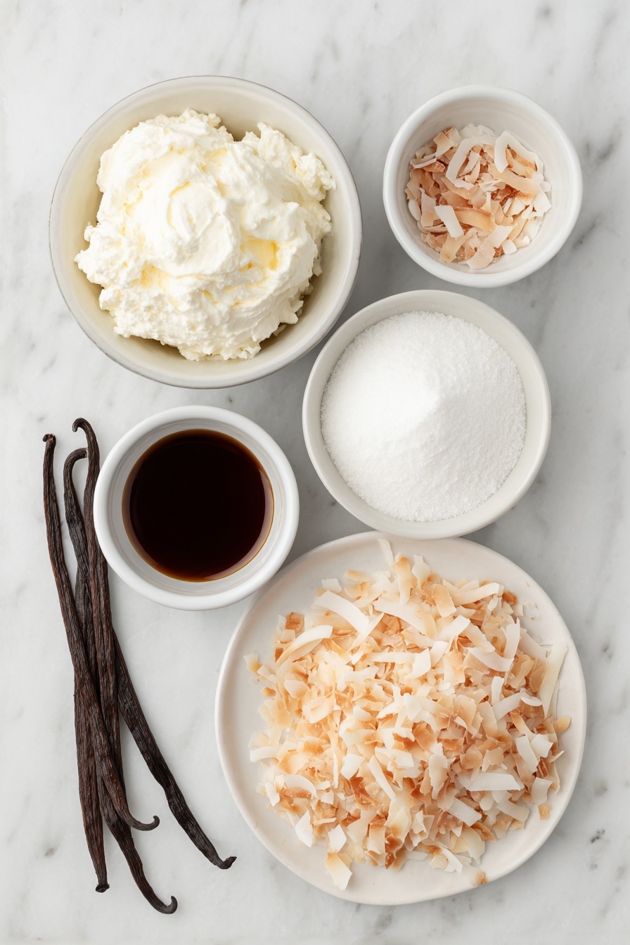 Flat lay of a small mound of cold heavy cream in a simple white ceramic bowl, a small white bowl filled with fine powdered sugar, a few whole brown vanilla beans beside a tiny white bowl holding vanilla extract, a larger white bowl containing cold full-fat coconut milk, a small white bowl with cold sweetened condensed milk, a tiny white bowl with coconut extract, and a neat pile of toasted unsweetened shredded coconut flakes on a white ceramic plate, all arranged symmetrically and naturally with fresh, unprocessed appearance placed on a clean white marble surface, soft natural light, photo taken with an iPhone, professional food photography style, fresh ingredients, white ceramic bowls, no bottles, no duplicates, no utensils, no packaging --ar 2:3 --v 7 --p m7354615311229779997 - Homemade Coconut Ice Cream, easy coconut ice cream without ice cream maker, tropical coconut ice cream recipe, dairy-free coconut ice cream, quick homemade coconut ice cream