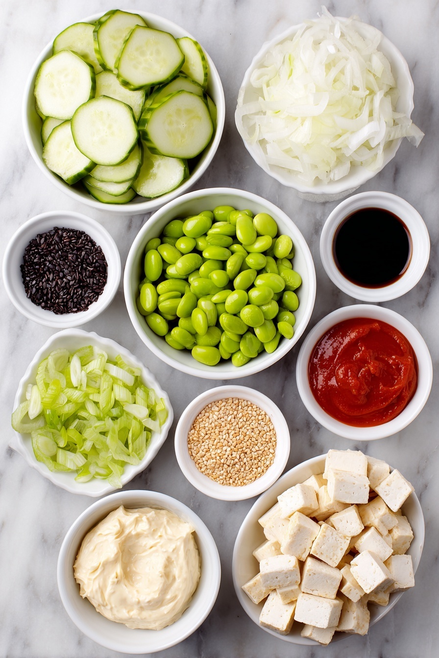 Flat lay of a whole fresh cucumber sliced into thin rounds, a small white ceramic bowl of thinly sliced white onion, a generous handful of golden crispy baked tofu cubes, a small white bowl filled with shelled bright green edamame, a white bowl with thin julienned orange carrot sticks, a small pile of sliced green spring onion, neatly cubed half avocado with vibrant green flesh, a small white bowl containing creamy vegan cream cheese, another small white bowl holding smooth vegan mayo, a small white bowl with bright red Sriracha sauce, a tiny white bowl filled with glossy chili-crisp oil, a small white bowl of dark soy sauce, a small white bowl scattered with light tan sesame seeds, and a small white bowl with delicate dark green crushed nori flakes, all perfectly arranged in balanced symmetry on a clean white marble surface, soft natural light, photo taken with an iPhone, professional food photography style, fresh ingredients, white ceramic bowls, no bottles, no duplicates, no utensils, no packaging --ar 2:3 --v 7 --p m7354615311229779997 - Creamy Asian Cucumber Salad Bowl, Asian cucumber salad, spicy cucumber salad, healthy cucumber salad, Asian-inspired salad